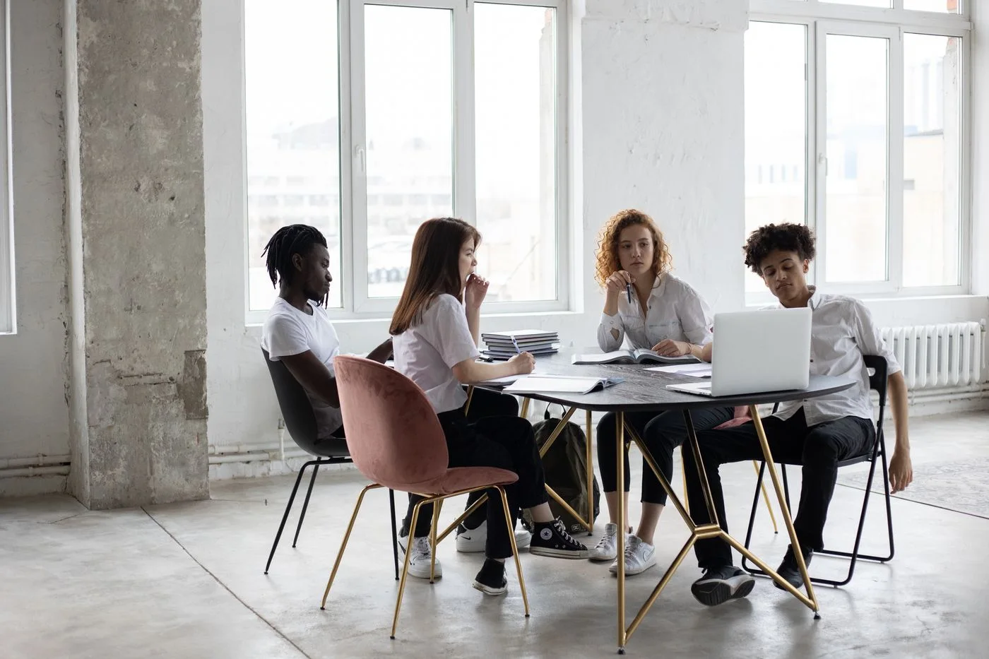 Four colleagues discussing a project around a shared table